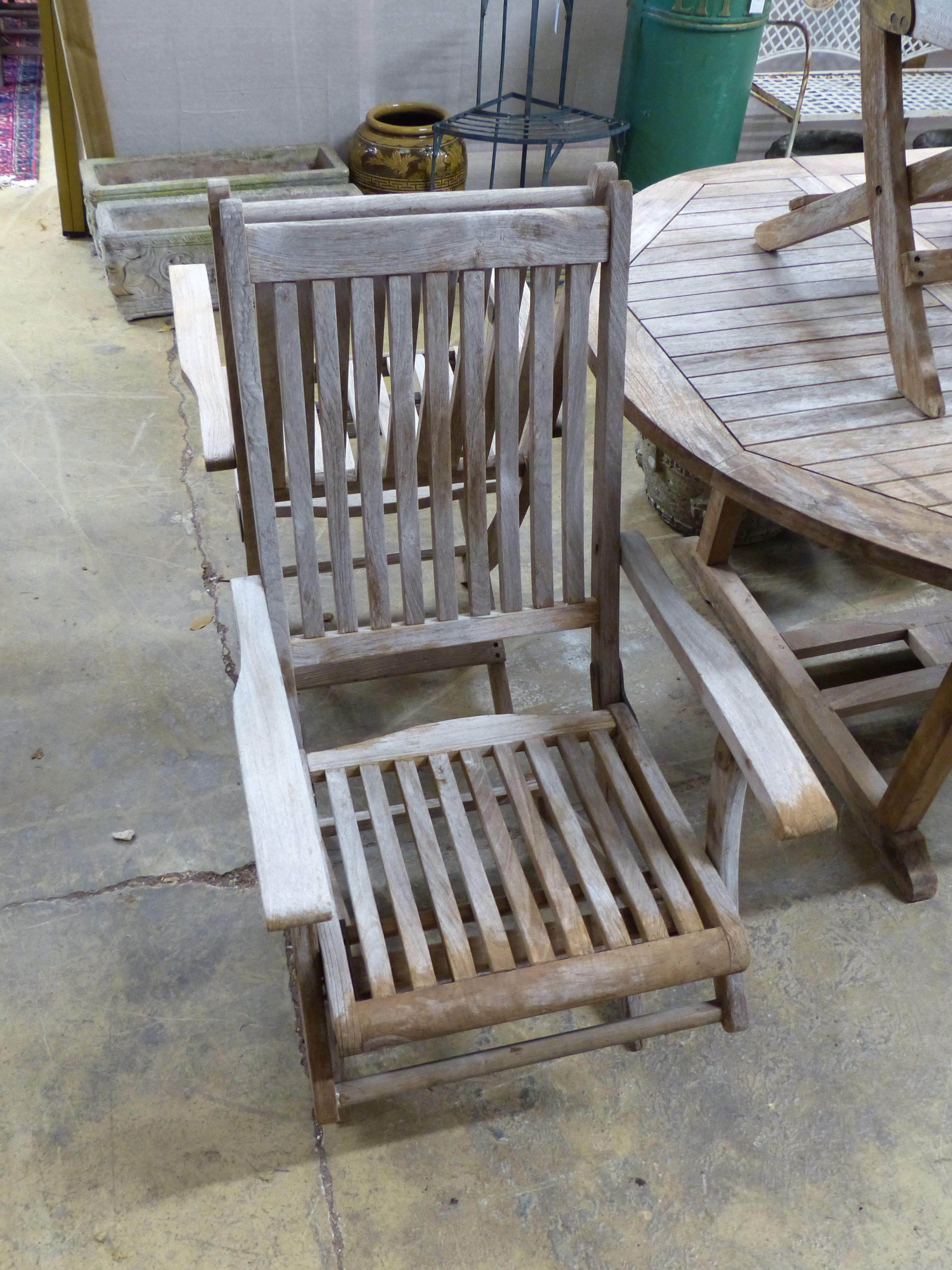 A 'Westminster' extending teak garden table, length 171cm and a set of six folding chairs